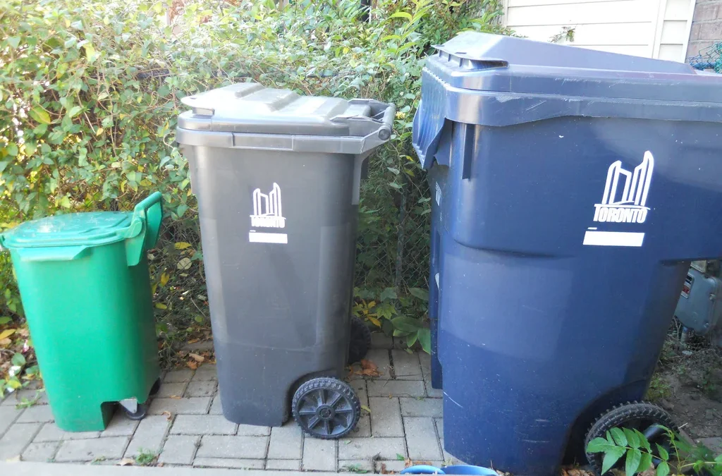 Green,grey and blue wheeled collection bins outside a Toronto home in 2010