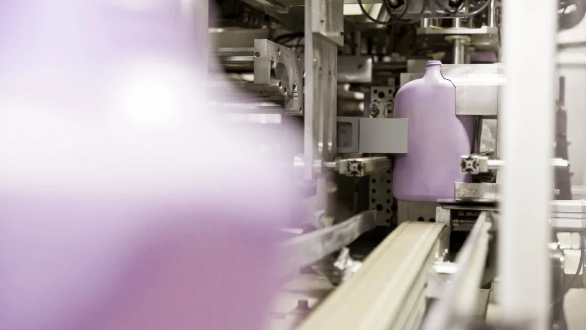 Unlabelled detergent bottles passing through production machinery