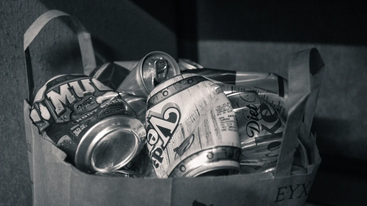 Used beverage cans collected in a paper grocery bag