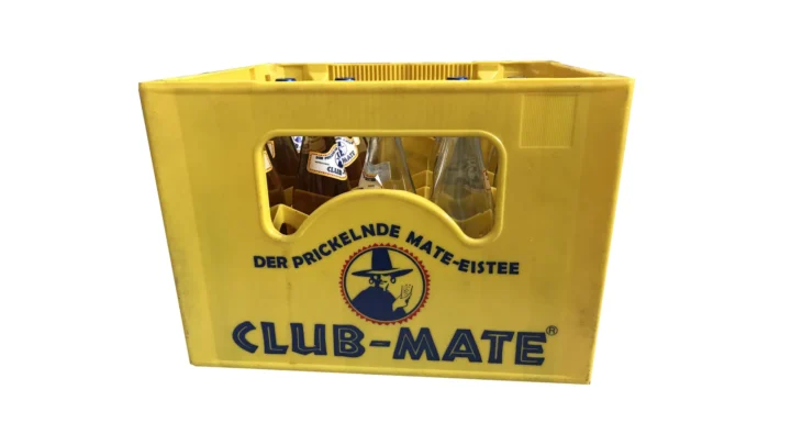 A yellow Club-Mate bottle crate holding full and empty glass bottles.
