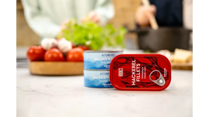 Two printed metal seafood cans in a kitchen setting.